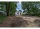 A spacious backyard featuring mature trees and landscaping, offering a private outdoor space at 1210 Cloninger Ave, Gastonia, NC 28052