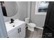Updated bathroom featuring a modern vanity, sleek black fixtures, and gray walls at 1210 Cloninger Ave, Gastonia, NC 28052