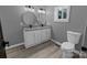 Modern bathroom featuring a double vanity with granite countertop and two round mirrors at 1210 Cloninger Ave, Gastonia, NC 28052