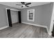 Bedroom with gray walls, updated flooring, a black ceiling fan, and a closet at 1210 Cloninger Ave, Gastonia, NC 28052