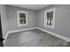 Bedroom featuring light gray walls and vinyl flooring, offering a bright and neutral space at 1210 Cloninger Ave, Gastonia, NC 28052