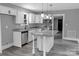 Bright kitchen with white cabinets, granite countertops, island with pendant lights, and stainless steel appliances at 1210 Cloninger Ave, Gastonia, NC 28052