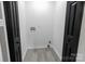 The laundry room features light gray vinyl flooring, modern white walls, and black doors at 1210 Cloninger Ave, Gastonia, NC 28052