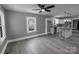 Open-concept living room with gray walls and flooring flowing into a bright modern kitchen with an island at 1210 Cloninger Ave, Gastonia, NC 28052