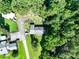 Aerial view of the home and property, surrounded by lush greenery and mature trees at 12143 Asbury Chapel Rd, Huntersville, NC 28078