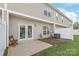 Exterior patio with fenced yard and double doors to the home at 12452 Stratfield Place Cir, Pineville, NC 28134