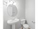 Clean bathroom featuring a pedestal sink, modern toilet, and stylish fixtures at 12452 Stratfield Place Cir, Pineville, NC 28134