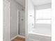 Bathroom featuring a shower with glass doors, a white soaking tub, and a window at 12452 Stratfield Place Cir, Pineville, NC 28134