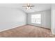 Bedroom featuring neutral-colored walls, carpeting, and a ceiling fan at 12452 Stratfield Place Cir, Pineville, NC 28134