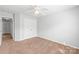 Bedroom features a ceiling fan, a double-door closet, neutral carpet, and white trim at 12452 Stratfield Place Cir, Pineville, NC 28134