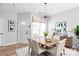Bright dining room featuring a stylish light fixture, wood floors, and ample natural light at 12452 Stratfield Place Cir, Pineville, NC 28134