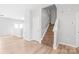 Hallway featuring a staircase, fresh paint, wood-look flooring, and neutral tones at 12452 Stratfield Place Cir, Pineville, NC 28134