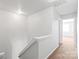 Hallway with white walls, carpeted stairs, and a view into another room at 12452 Stratfield Place Cir, Pineville, NC 28134