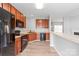 Bright kitchen featuring wood cabinets, black appliances, and a breakfast bar connecting to the living area at 12452 Stratfield Place Cir, Pineville, NC 28134