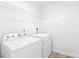 Efficient laundry room with a washer, a dryer, and a wire shelf for storage at 12452 Stratfield Place Cir, Pineville, NC 28134