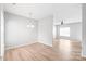 Open-concept living room with modern flooring, bright lighting, and versatile layout at 12452 Stratfield Place Cir, Pineville, NC 28134
