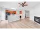 Inviting space featuring a fireplace, modern flooring, an open layout, and a ceiling fan at 12452 Stratfield Place Cir, Pineville, NC 28134