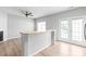 Open-concept living space with light grey walls, natural light, and light-colored flooring at 12452 Stratfield Place Cir, Pineville, NC 28134