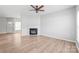 Spacious living area featuring a fireplace, modern flooring, ample natural light, and neutral tones at 12452 Stratfield Place Cir, Pineville, NC 28134