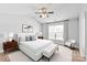 Airy main bedroom with a ceiling fan, large window, stylish furniture, and a relaxing atmosphere at 12452 Stratfield Place Cir, Pineville, NC 28134