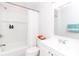 Bright bathroom with a combined shower-tub, white vanity, and a modern mirror at 13414 Central Ave, Huntersville, NC 28078