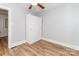 Bright bedroom with ceiling fan, wood-look floors and white closet at 13414 Central Ave, Huntersville, NC 28078