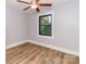 Serene bedroom with hardwood floors, light gray walls and a window view at 13414 Central Ave, Huntersville, NC 28078