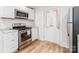 Well-equipped kitchen with stainless steel appliances, granite counters, and white cabinetry at 13414 Central Ave, Huntersville, NC 28078