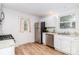 Updated kitchen with white cabinets, stainless appliances, and granite countertops at 13414 Central Ave, Huntersville, NC 28078