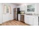 Bright kitchen featuring stainless steel appliances and white cabinetry with granite countertops at 13414 Central Ave, Huntersville, NC 28078