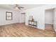 Inviting living room with wood floors, white walls, black trim window, and ceiling fan at 13414 Central Ave, Huntersville, NC 28078