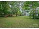 Expansive backyard featuring lush greenery and a play set, perfect for outdoor activities and Gathering fun at 13416 Kintyre Ct, Matthews, NC 28105