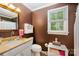 Well-lit bathroom featuring a vanity, sink, and natural light at 13416 Kintyre Ct, Matthews, NC 28105
