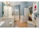 Bathroom with white cabinets and beadboard walls, tiled shower, and window at 13416 Kintyre Ct, Matthews, NC 28105