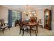 Cozy dining room with a chandelier, wooden table, and patterned chairs, creating an inviting space at 13416 Kintyre Ct, Matthews, NC 28105