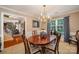 Elegant dining room featuring a chandelier, wooden table, and charming decor, perfect for dinners at 13416 Kintyre Ct, Matthews, NC 28105