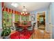 Bright dining room with wood floors, skylights, and bay window with custom valance at 13416 Kintyre Ct, Matthews, NC 28105