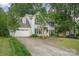 Beautiful exterior view of a two-story home with an attached garage and a long driveway at 13416 Kintyre Ct, Matthews, NC 28105