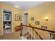 Upstairs hallway with carpeted floors and wood railing leading to bedrooms at 13416 Kintyre Ct, Matthews, NC 28105