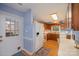 Eat-in kitchen with wood cabinets, white appliances, and built-in desk area at 13416 Kintyre Ct, Matthews, NC 28105