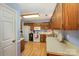 Functional kitchen with wooden cabinets, white appliances, and a practical layout for cooking at 13416 Kintyre Ct, Matthews, NC 28105