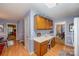 Eat-in kitchen features light wood floors, wainscoting, and custom built-in desk at 13416 Kintyre Ct, Matthews, NC 28105