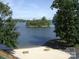 Private beach featuring benches, picnic tables and scenic views of an island on the beautiful lake at 14529 Waterside Dr, Charlotte, NC 28278