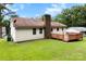 Home exterior featuring a deck, brick chimney, and spacious grassy yard at 1617 Mulberry Cir, Rock Hill, SC 29732