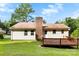 Home's backyard features a wood deck, brick chimney, and a large green lawn at 1617 Mulberry Cir, Rock Hill, SC 29732