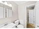 Bathroom with white sink, toilet, cabinets, and a door to the tub area at 1617 Mulberry Cir, Rock Hill, SC 29732