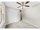 Bedroom featuring neutral carpet, a ceiling fan, and a closet with bi-fold doors at 1617 Mulberry Cir, Rock Hill, SC 29732