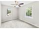 Bright bedroom featuring two windows, neutral walls, carpet flooring, and ceiling fan at 1617 Mulberry Cir, Rock Hill, SC 29732