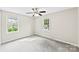 Bedroom with neutral carpet, a ceiling fan, and natural light from two windows at 1617 Mulberry Cir, Rock Hill, SC 29732