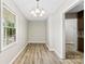 Dining room with window, chandelier, and wood laminate flooring at 1617 Mulberry Cir, Rock Hill, SC 29732